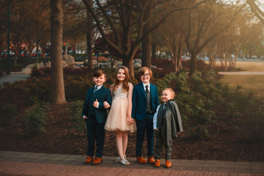 Four siblings standing together on the engraved brick walkway at Centennial Olympic Park in Atlanta, GA.