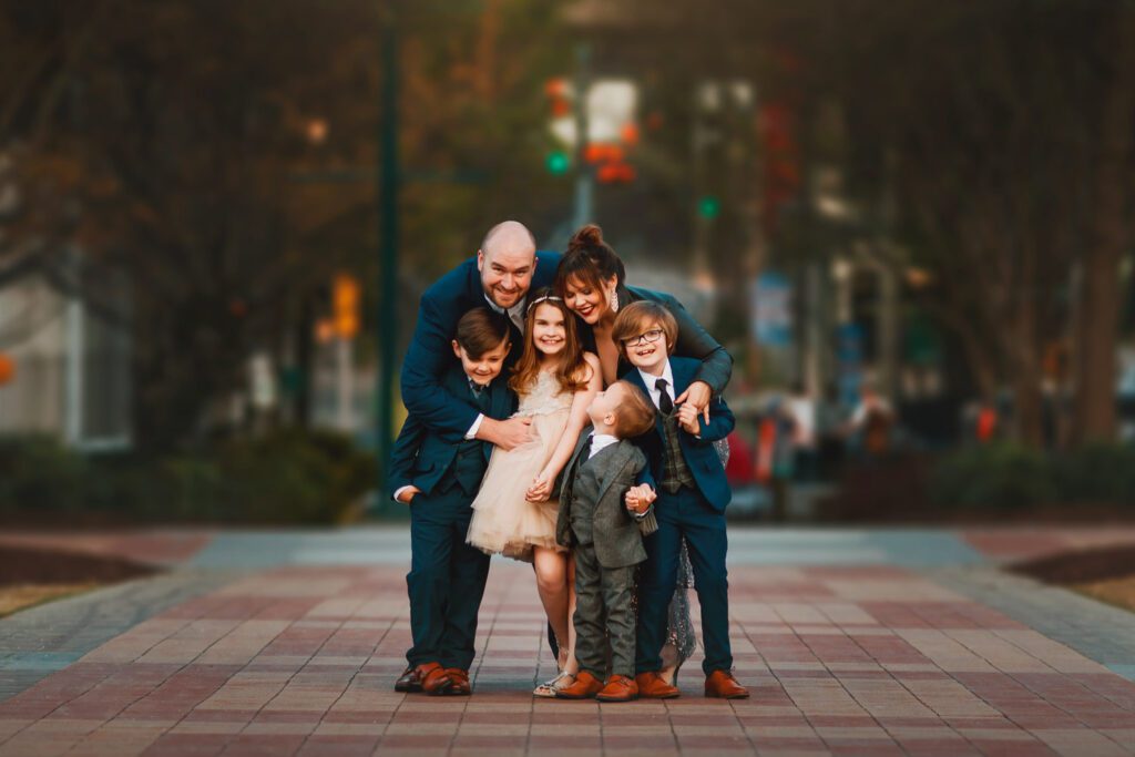 family hugging while standing on the commemorative brick walkway at Centennial Olympic Park