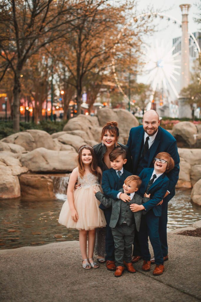 family standing together in front of water gardens at Centennial Olympic Park.