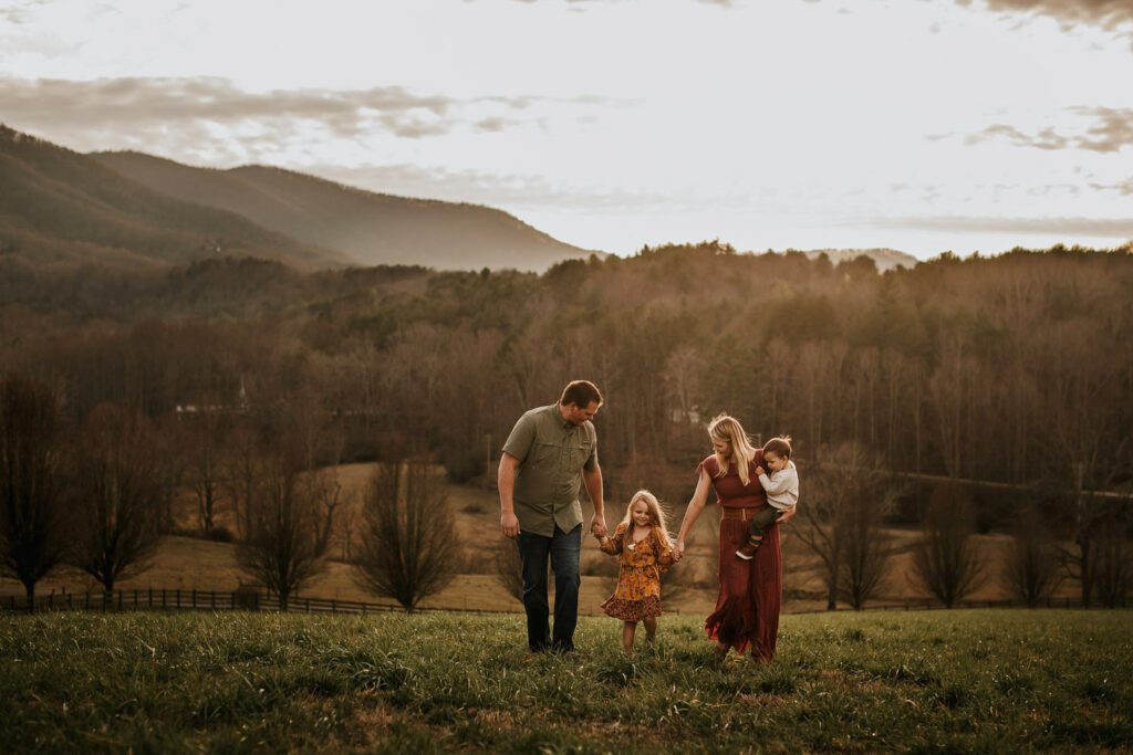 Warm fall color palette of outfits as the daughter wears a yellow and red floral dress and the family wears red and green. 